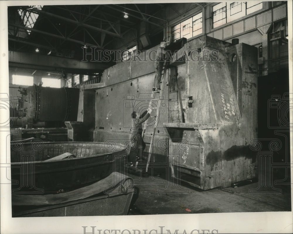 1957 Press Photo Workers at A O Smith Corporation work on huge machine part- Historic Images