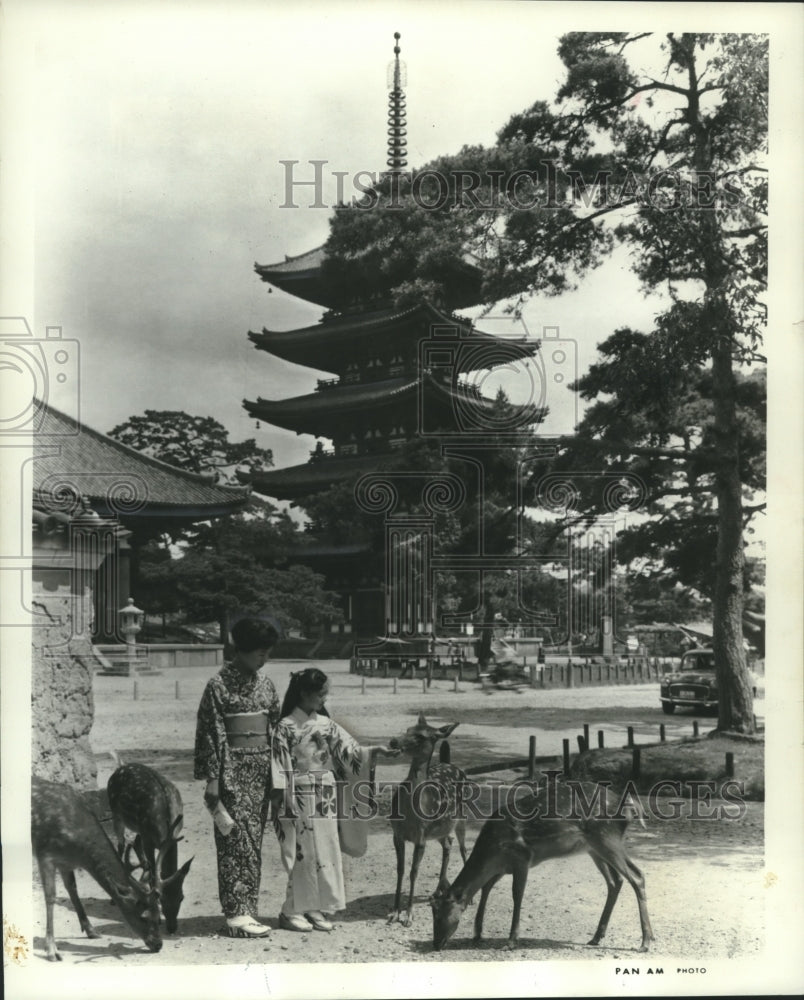 1964 Press Photo Woman and girl with sacred deer at Shinto temple, Nara, Japan- Historic Images