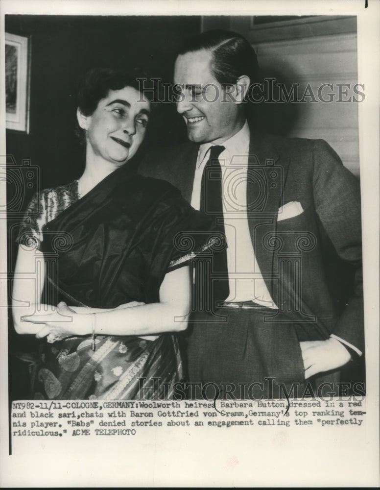 Load image into Gallery viewer, 1951 Press Photo Woolworth heiress, Barbara Hutton chats with Baron von Gramm.
