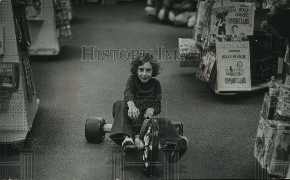 1977 Press Photo Child Rides Bike in Store - mjc11556- Historic Images