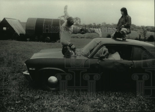 1990 Press Photo Students of Stunt Education School of America practice on a car- Historic Images