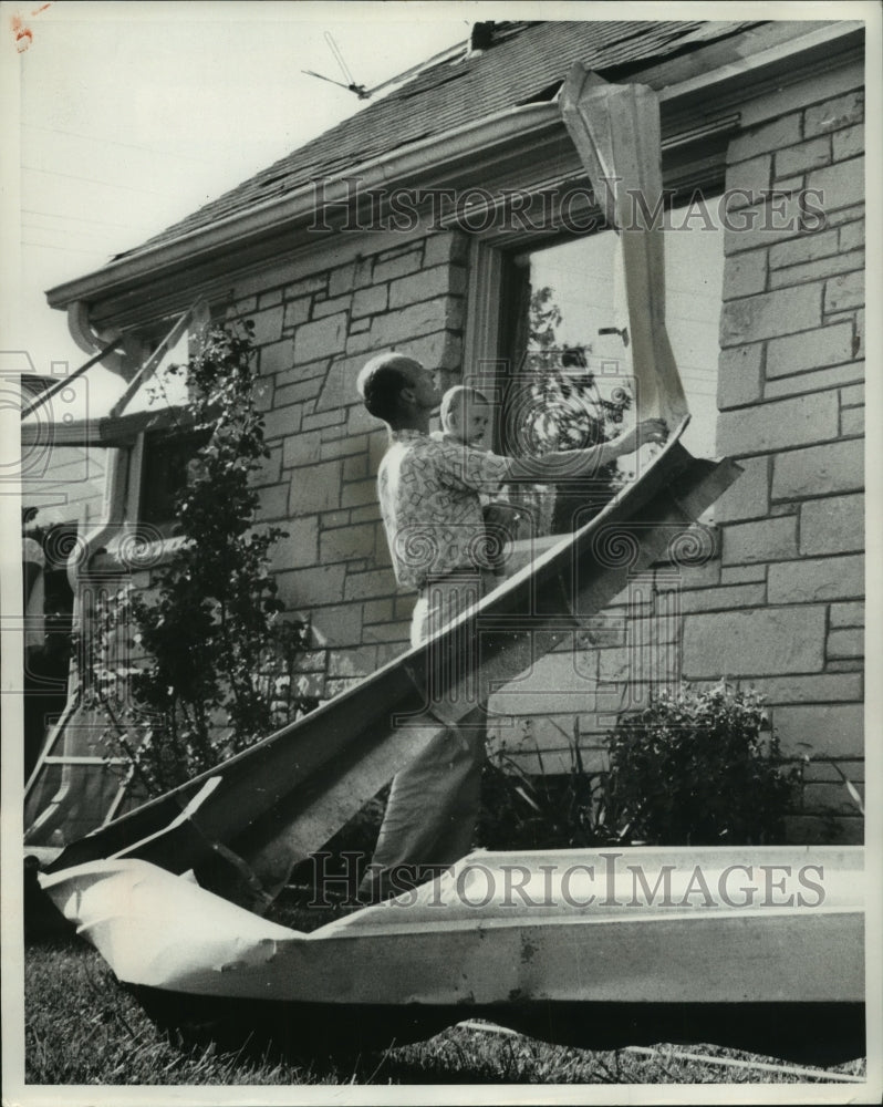 1958 Press Photo Walter Hirschi examines his tornado damage home, Wisconsin- Historic Images