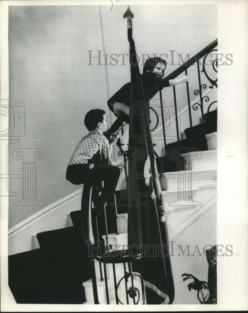 Load image into Gallery viewer, 1960 Press Photo Gaylord Nelson Jr. &amp; Cynthia Nelson glide down curved banister
