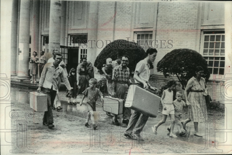 Load image into Gallery viewer, 1964 Press Photo Families leave Red Cross center to safety inland Lake Charles
