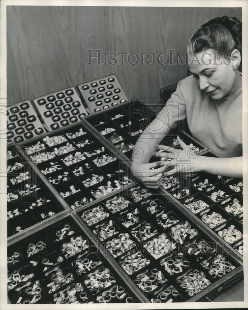 1952 Press Photo Woman Tries On Ring At A Table Full Of Rings - mjc24735- Historic Images