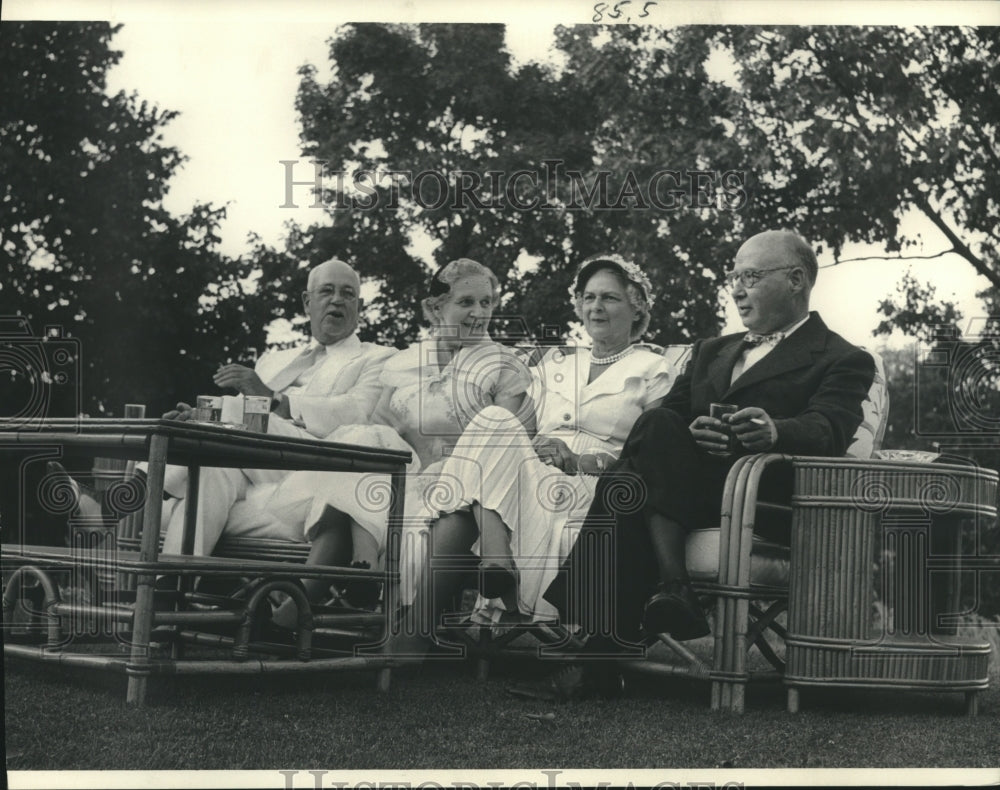 1952 Press Photo Irving Seaman and others relaxing on the lawn swing.