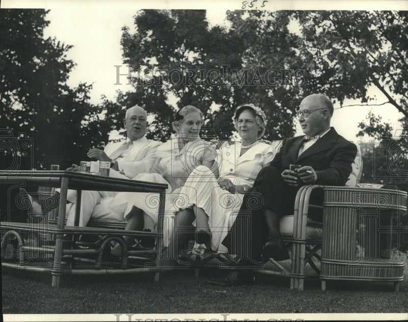 Load image into Gallery viewer, 1952 Press Photo Irving Seaman and others relaxing on the lawn swing.
