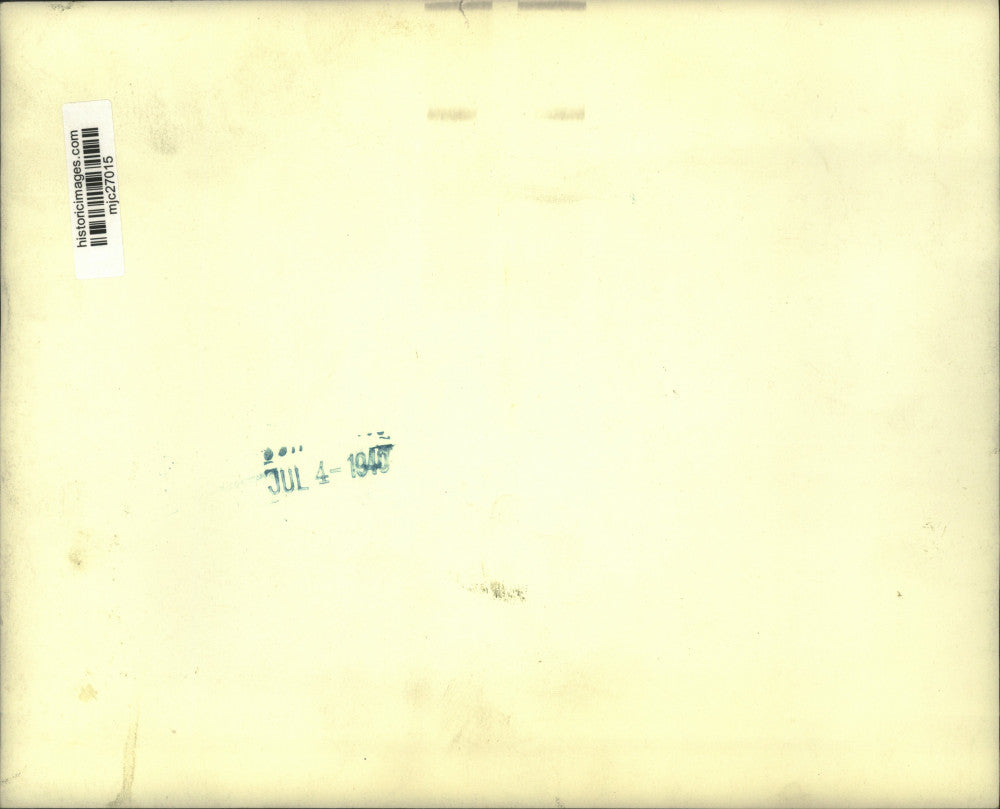 1940 Press Photo Unknown woman walking beside garden behind residence