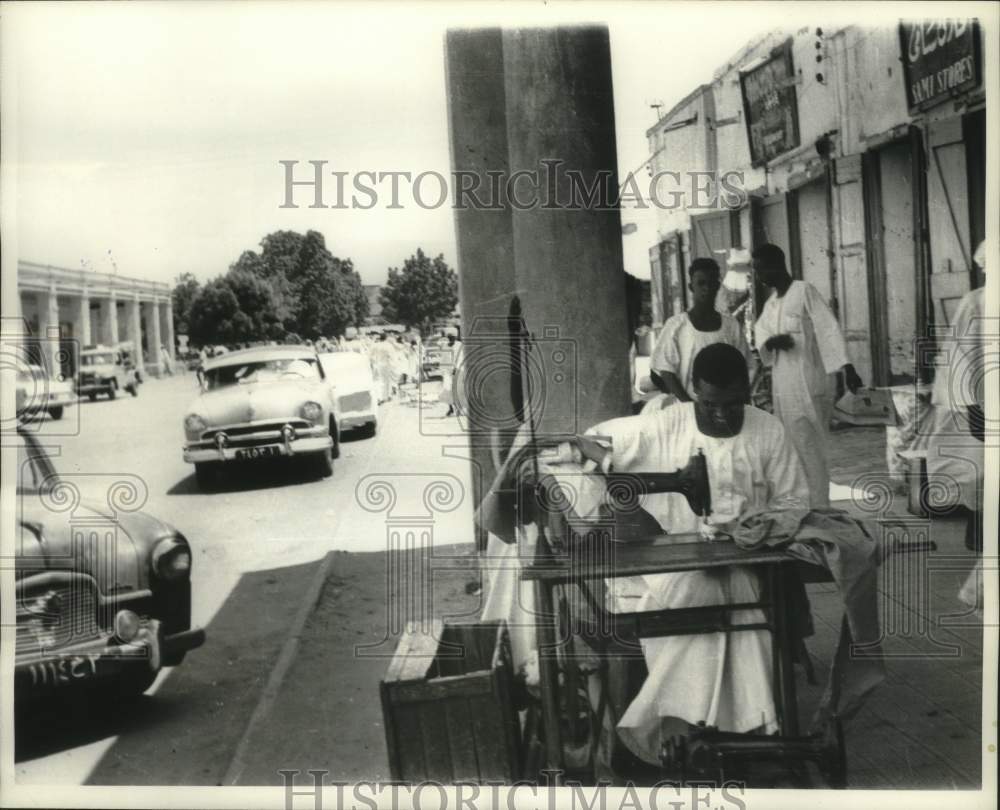 1964 Press Photo Tailor works in front of textile shop in Khartoum, Sudan- Historic Images