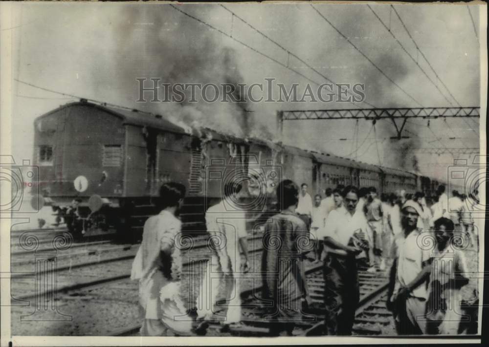 1966 Press Photo Demonstrators set train on fire near Calcutta, India