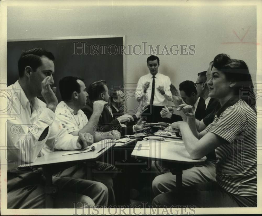 1961 Press Photo Signing is being taught to employees of Lockheed in California.- Historic Images