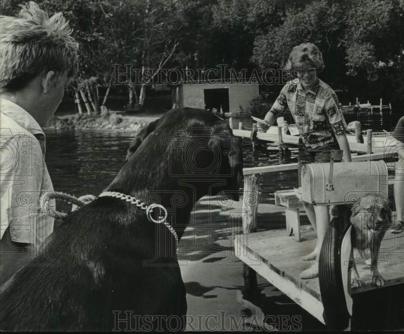 Load image into Gallery viewer, 1964 Press Photo Post Office route walks past an anti-mailman dog who growls.
