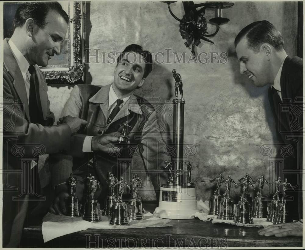 1949 Press Photo Men's bowling team members admire trophies at Journal party