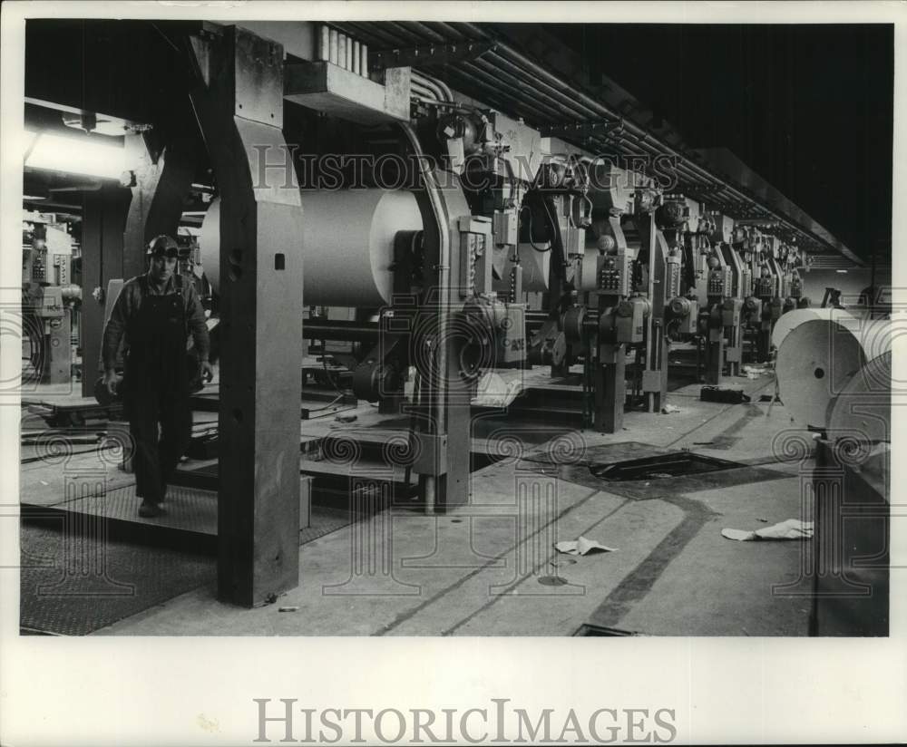 1962 Press Photo Employee walks across press room, Milwaukee Journal - mjc37166- Historic Images