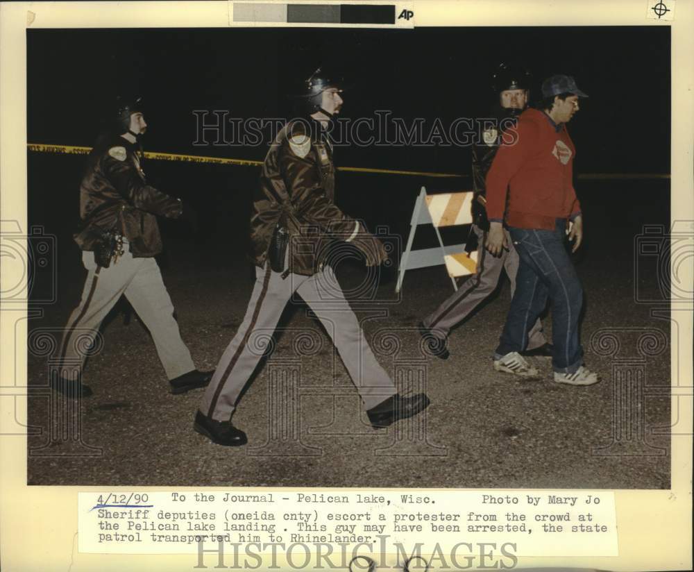 1990 Press Photo Man arrested at Pelican Lake protest in Wisconsin. - mjc38216
