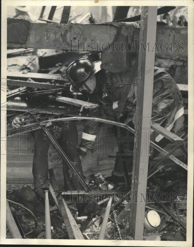 1965 Press Photo Fireman clears burned out building, Milwaukee - mjc38911- Historic Images