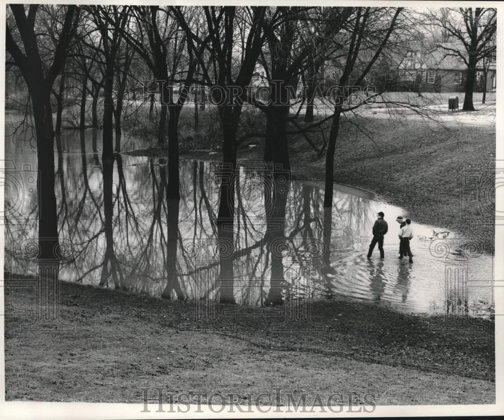 1959 Press Photo Boys walk in flooded trees along Menomonee River, Wauwatosa WI.