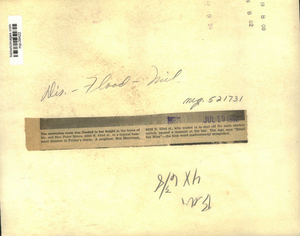 1952 Press Photo Man wades into flooded basement to shut off the power