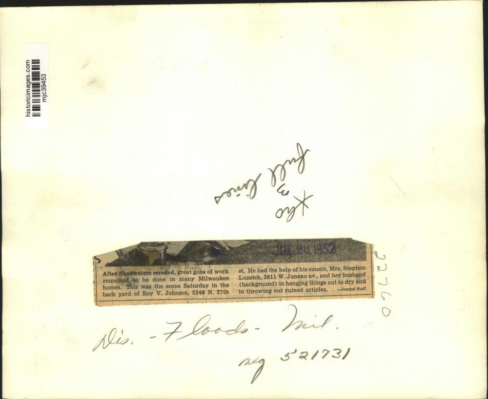 1952 Press Photo Roy V. Johnson Works to Clean Up Home After Flood in Milwaukee