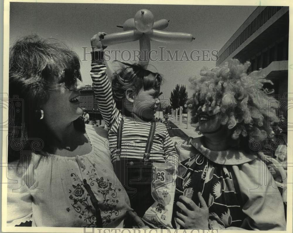 1983 Press Photo Clown gives a kid a balloon animal, Performing Arts Center, WI- Historic Images