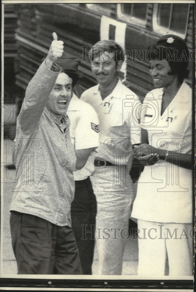 Load image into Gallery viewer, 1973 Press Photo Former POW Navy captain gives thumbs up sign, Hanoi
