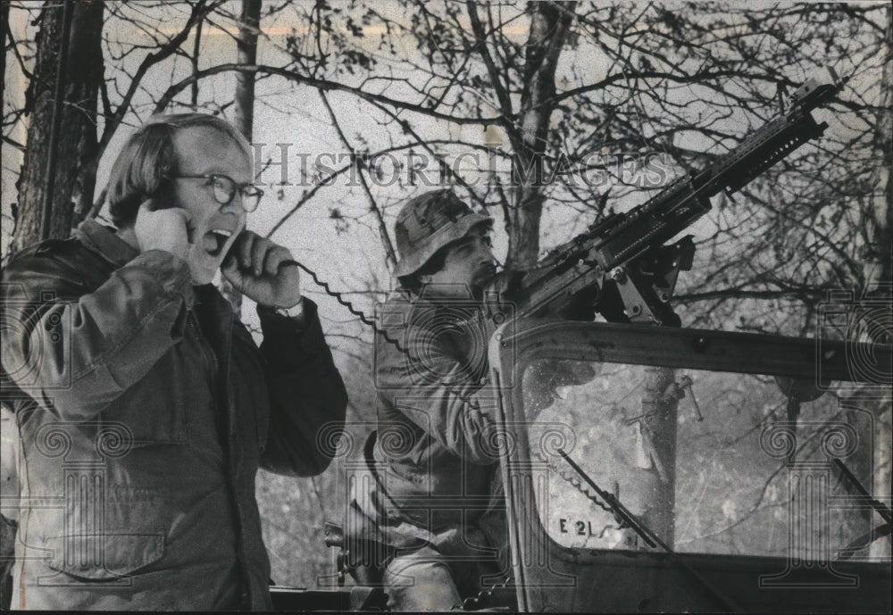1970 Press Photo Gary Whitney holds ears as Jerry Smith fires gun, Wisconsin