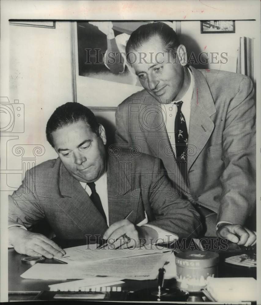 1951 Press Photo Roy Hamey signs papers. - mjm11723- Historic Images