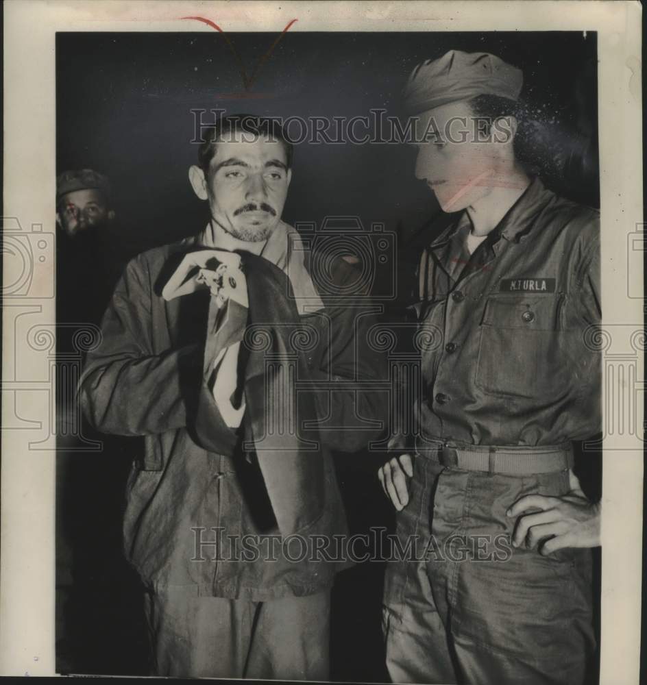 1953 Press Photo Turkish soldier holds flag during prisoner of war swap in Korea- Historic Images