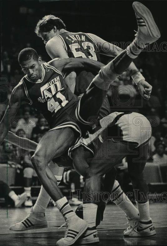 1986 Press Photo Utah's Thurl Bailey tumbles over Bucks Ricky Pierce in game- Historic Images
