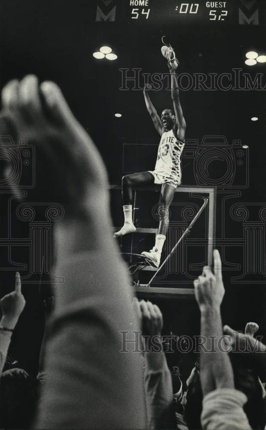 1981 Press Photo Marquette's Michael Wilson sits on backboard after win at Arena- Historic Images