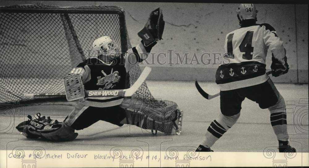 1985 Press Photo Muskegon goalie Michel Dufour stops shot by Kevin Robinson- Historic Images