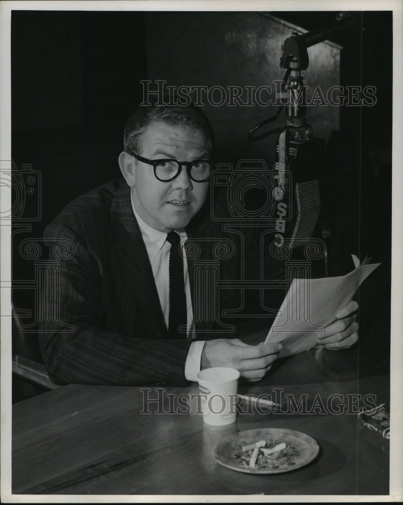 Press Photo Radio&#39;s Stan Delberg reading at desk with coffee &amp; cigarettes- Historic Images