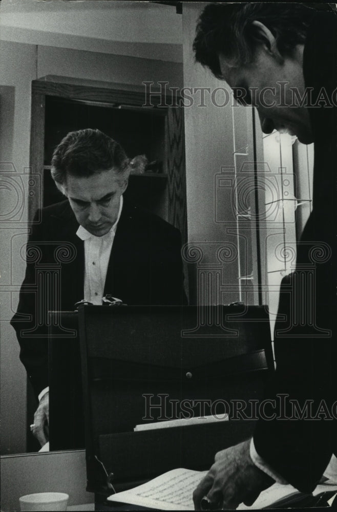 Press Photo Milwaukee Symphony conductor, Kenneth Schermerhorn checks his music.- Historic Images