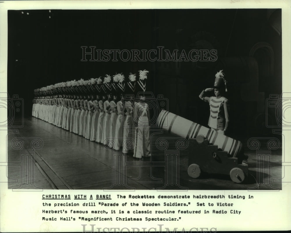 1986 Press Photo The Rockettes with cannon in Parade of the Wooden Soldiers- Historic Images