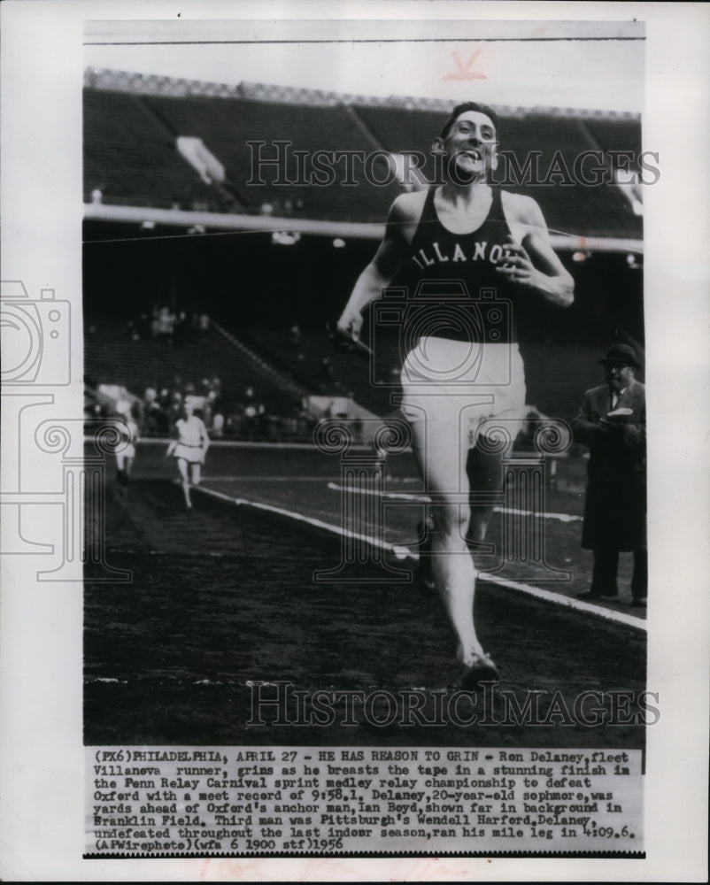 1956 Press Photo Ron Delany crosses finish line in sprint medley relay event- Historic Images