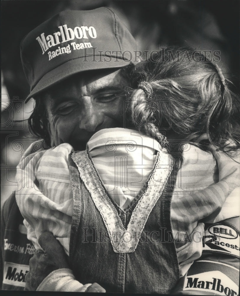 1988 Press Photo Emerson Fittipaldi wins race and gets hug from daughter.- Historic Images