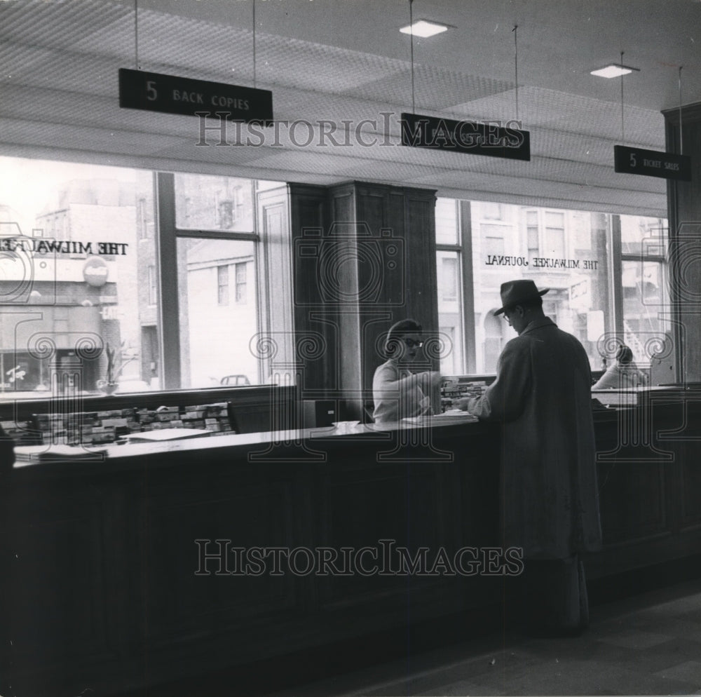 1956 Press Photo Employee Helps Customer In Public Section Of Journal Lobby- Historic Images