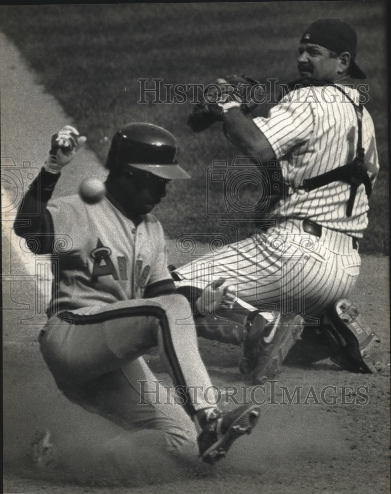 1991 Press Photo - County Stadium, Luis Polonia of the Angels slides home safely- Historic Images