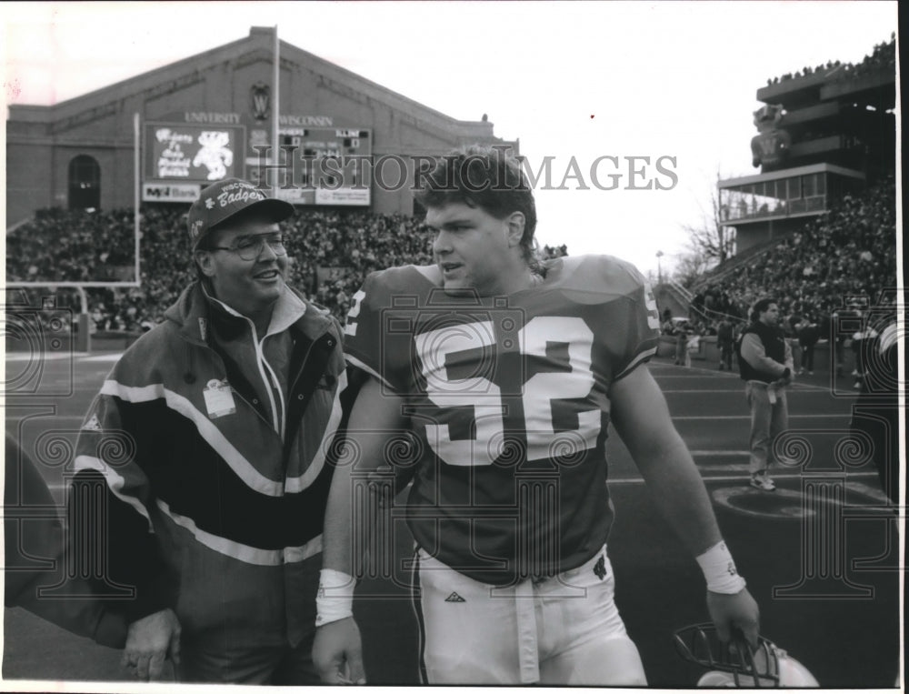 1994 Press Photo Cory Raymer with father, Mark, at game at Camp Randall Stadium.- Historic Images