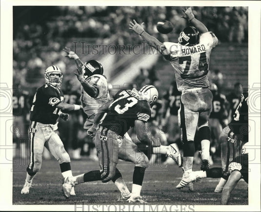 1986 Press Photo Packers quarterback throwing a pass and defenders jumping up.- Historic Images