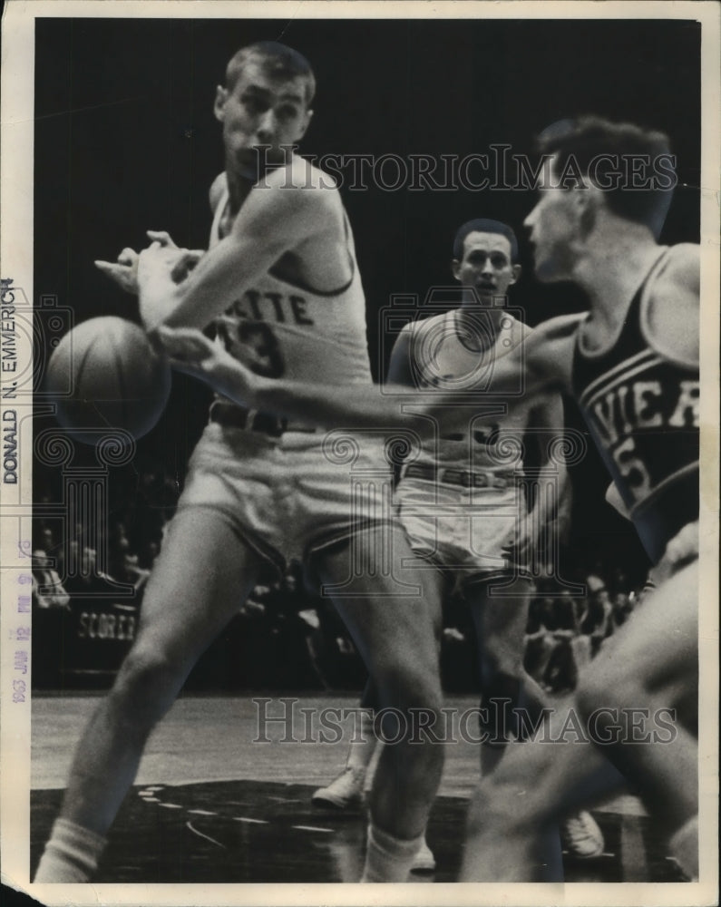 1963 Press Photo Xavier player slaps ball from Marquette basketball&#39;s Ron Glaser- Historic Images