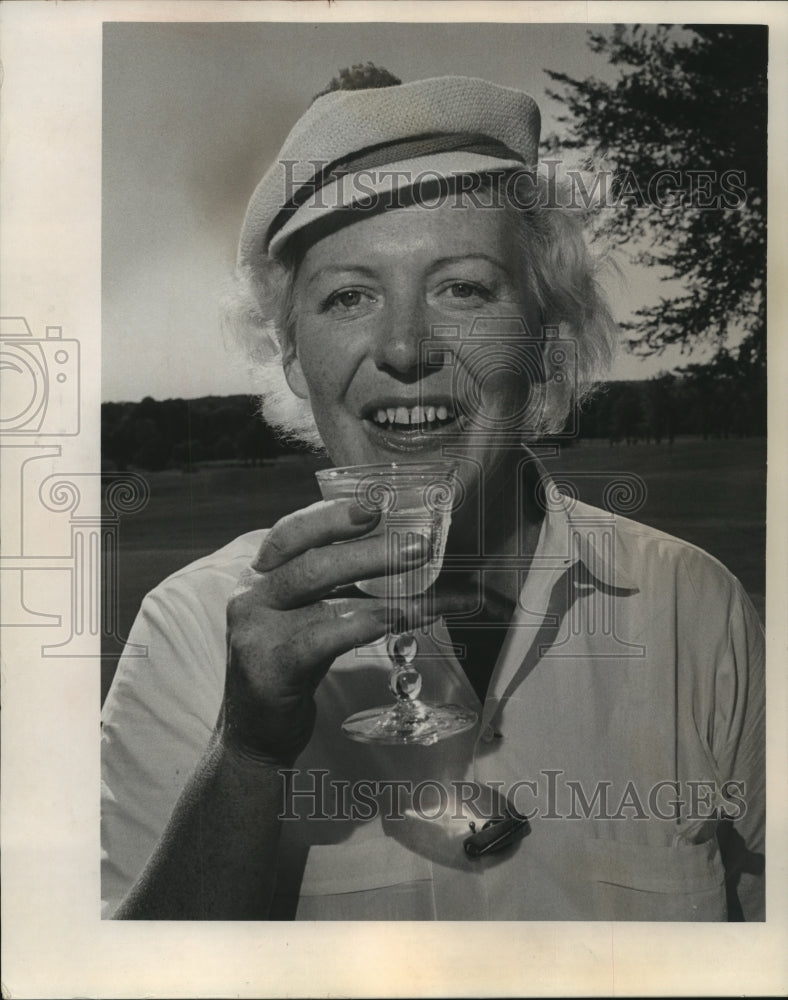1964 Press Photo Champion Mrs. Paula Clauder toasts 10th Metro Crown in 25 years- Historic Images