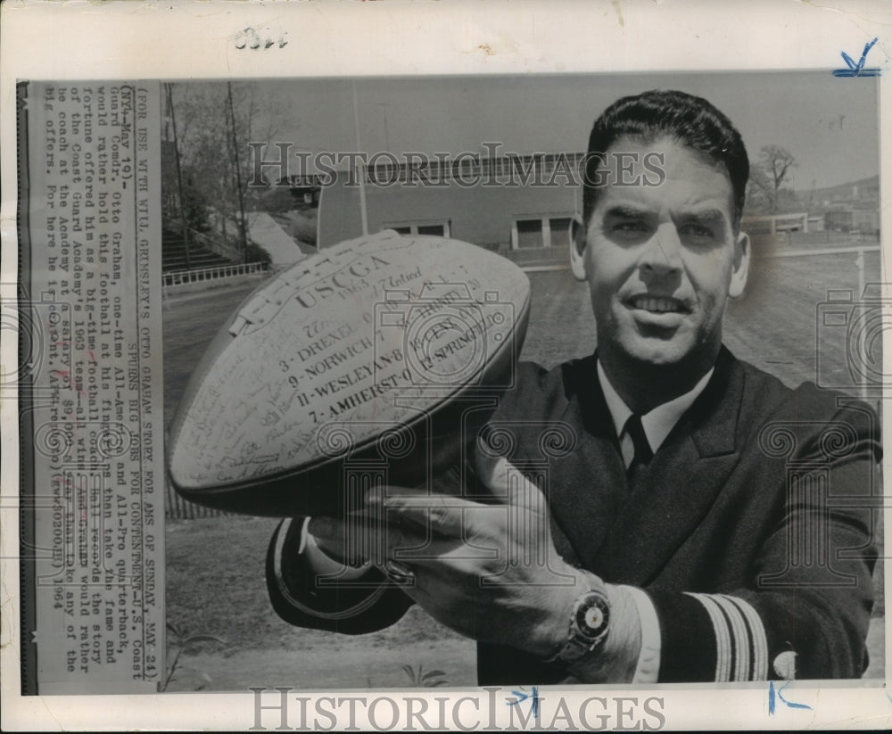 1964 Press Photo Guard Commander Otto Graham holds 1963 winning team football- Historic Images