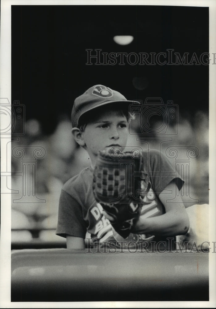 1992 Press Photo Baseball fan Ryan Antoine watches Brewers game during Glove Day- Historic Images