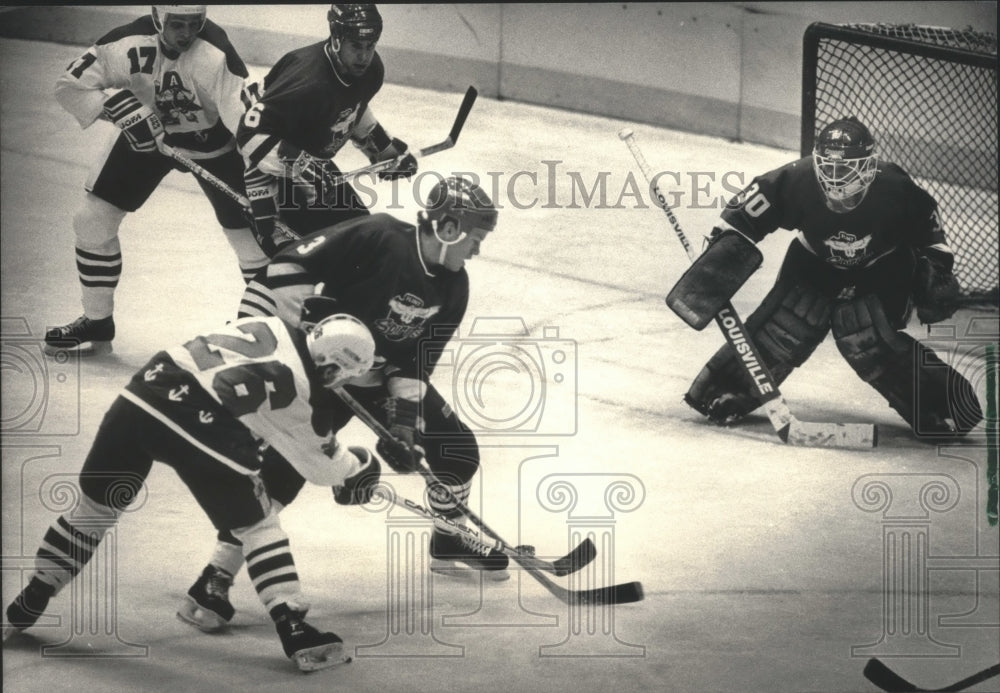 1986 Press Photo Kevin Schamehorn, Admirals, Eric Germain, Flint battle for puck- Historic Images