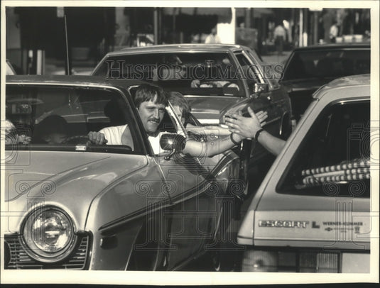 1987 Press Photo Motorists on Wisconsin Avenue exchange 'high five.' - mjt13261- Historic Images