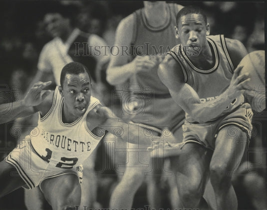 1985 Press Photo Marquette's freshman Michael Sims reaching to steal basketball.- Historic Images