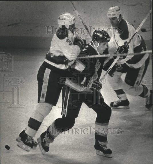 1991 Press Photo Admirals' Steve Villeux checks Miller to allow McBain to puck.- Historic Images