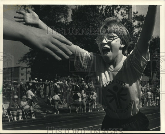 1988 Press Photo Kristie Heim crosses finish line in Wisconsin Special Olympics- Historic Images