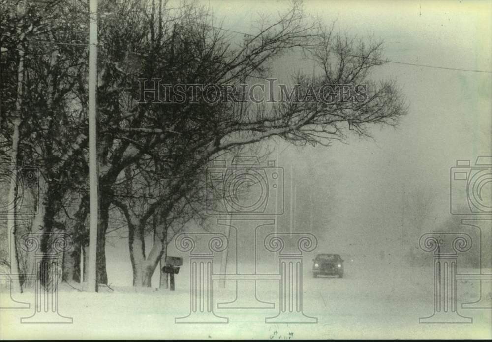 1983 Press Photo Car driving through snowstorm in Wisconsin - mjt19127- Historic Images